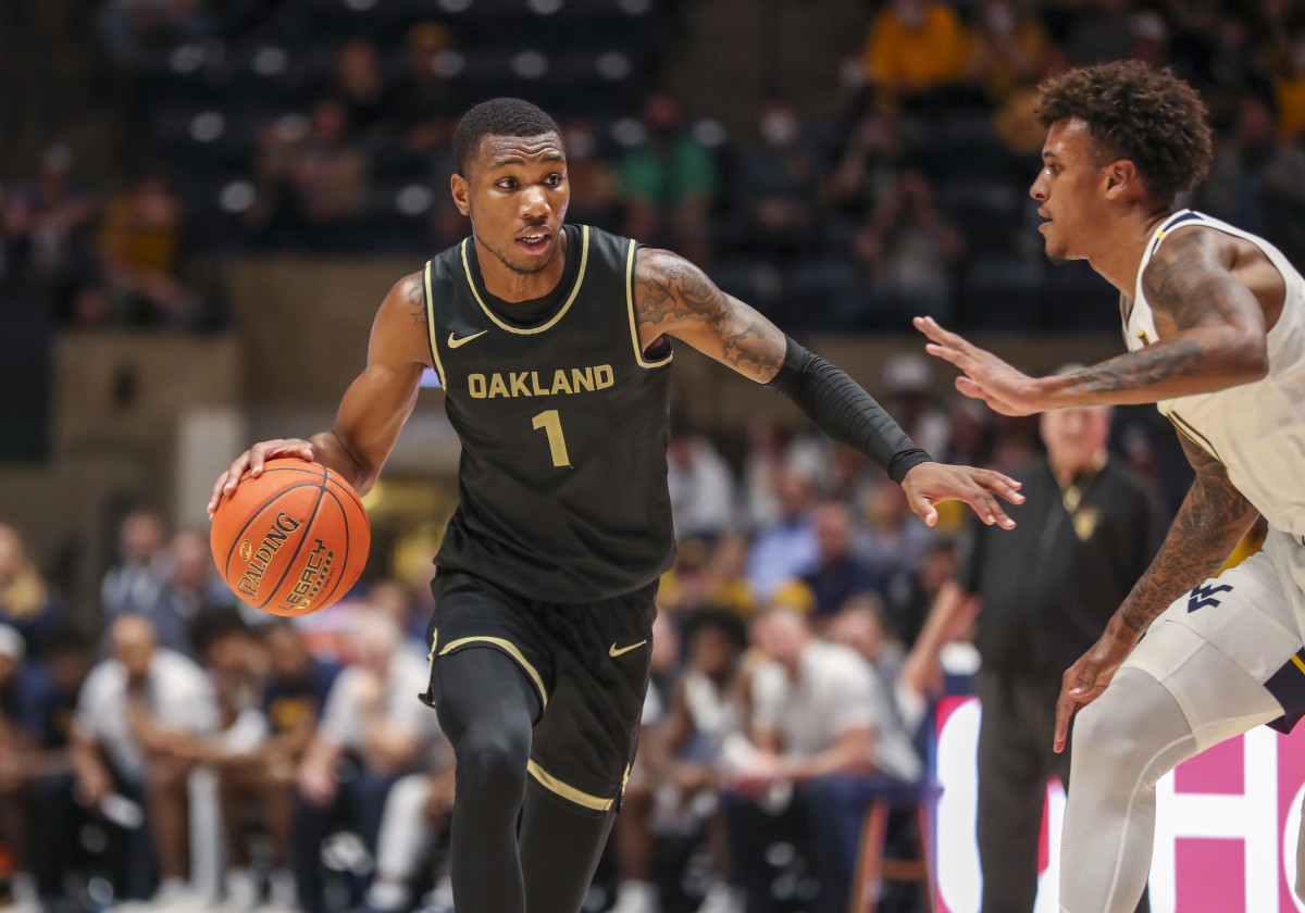 Oakland Golden Grizzlies forward Jamal Cain (1) dribbles the ball during the second half against the West Virginia Mountaineers at WVU Coliseum.