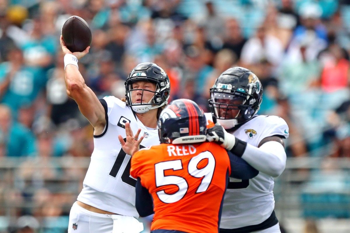 Jacksonville Jaguars quarterback Trevor Lawrence (16) throws a pass against Denver Broncos linebacker Malik Reed (59) during the first quarter at TIAA Bank Field.