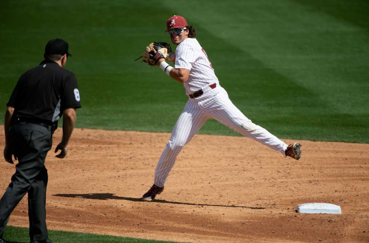 Alabama infielder Bryce Eblin (13) loses control of the ball as he attempts to turn a double play in the game with Georgia Saturday, April 23, 2022, at Sewell-Thomas Stadium.