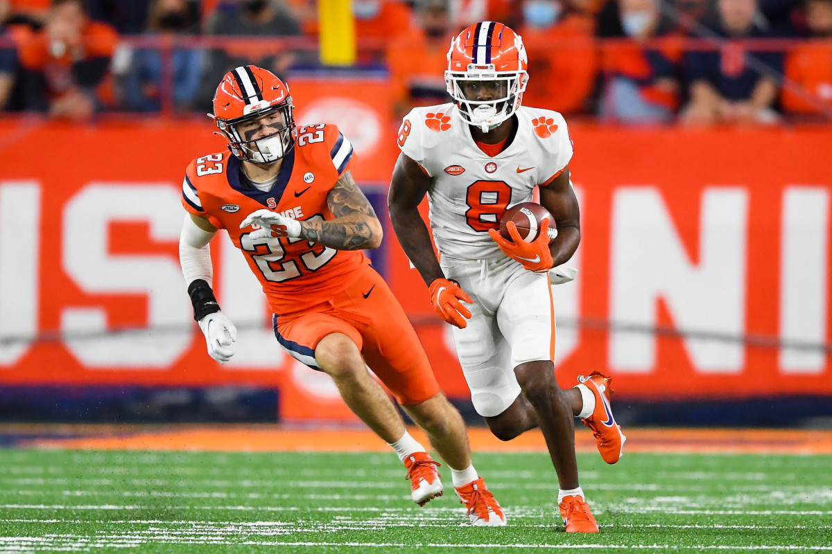 Oct 15, 2021; Syracuse, New York, USA; Clemson Tigers wide receiver Justyn Ross (8) runs with the ball past Syracuse Orange defensive back Justin Barron (23) during the second half at the Carrier Dome. Mandatory Credit: Rich Barnes-USA TODAY Sports