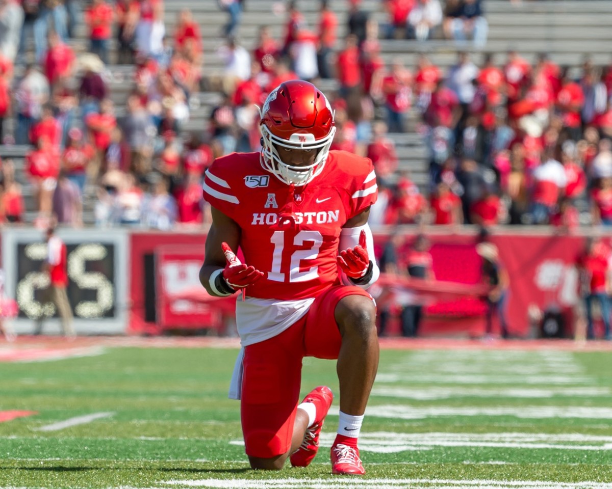 Houston Cougars defensive lineman David Anenih (12) kneels after the run out prior to the game between Houston Cougars and Cincinnati Bearcats at TDECU Stadium.