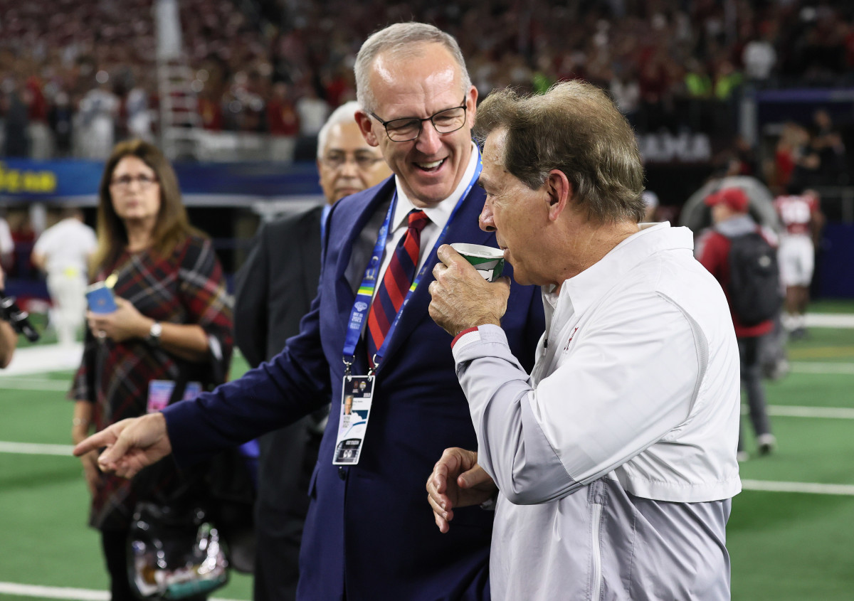 SEC commissioner Greg Sankey talks with head coach Nick Saban after a victory against the Cincinnati Bearcats during the 2021 Cotton Bowl college football CFP national semifinal game at AT&T Stadium.