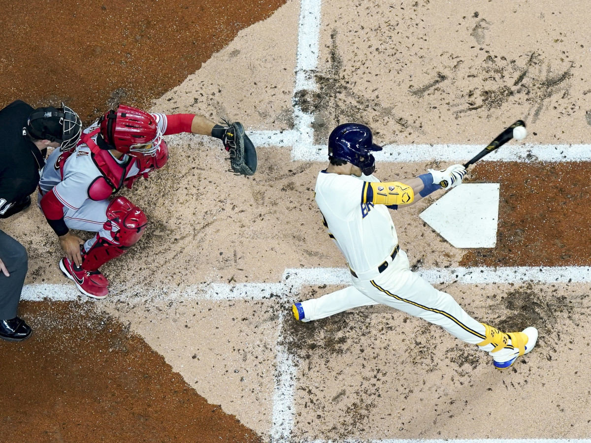 Milwaukee Brewers’ Christian Yelich hits a double during the first inning of a baseball game against the Cincinnati Reds Wednesday, May 4, 2022, in Milwaukee.