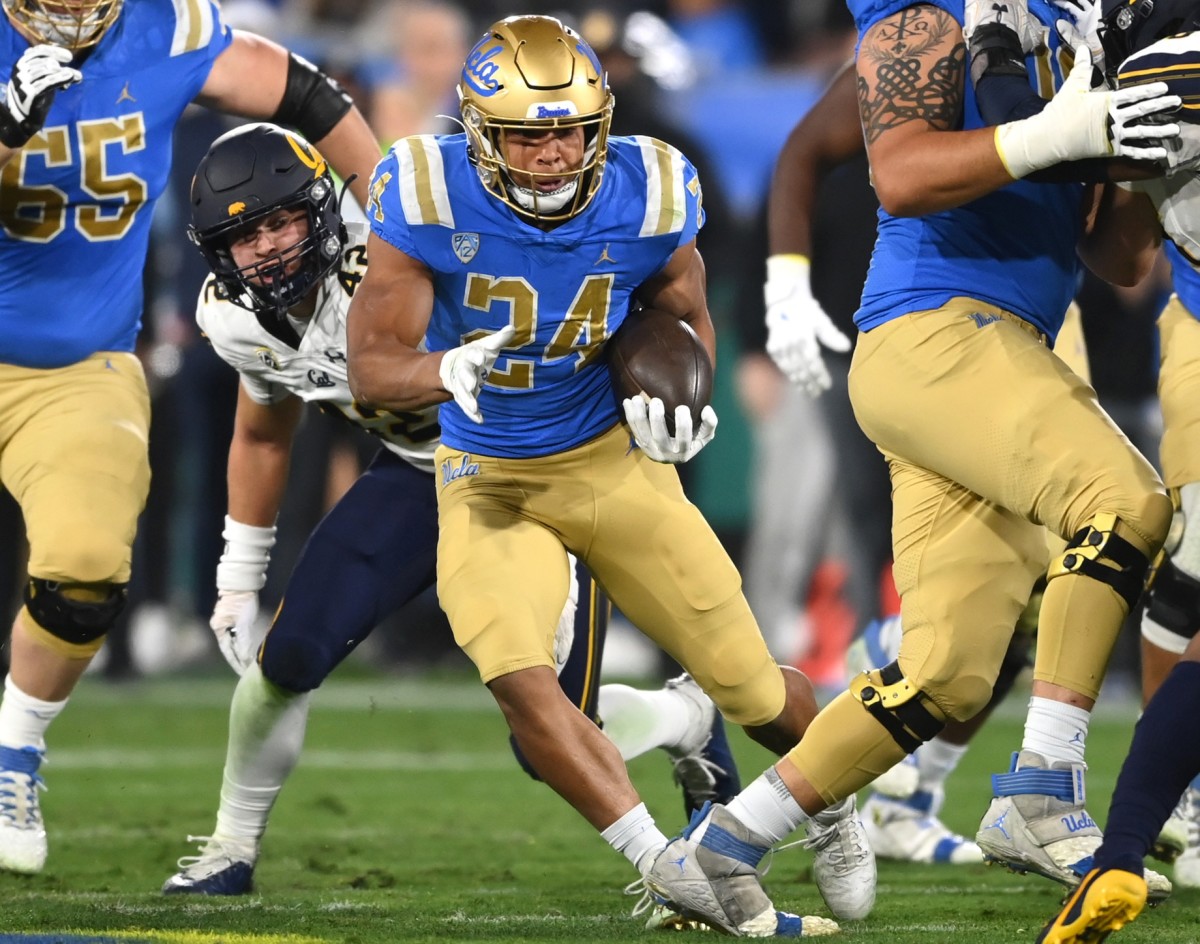 Nov 27, 2021; Pasadena, California, USA; UCLA Bruins running back Zach Charbonnet (24) carries the ball for a first down against the California Golden Bears in the first half at the Rose Bowl. Mandatory Credit: Jayne Kamin-Oncea-USA TODAY Sports