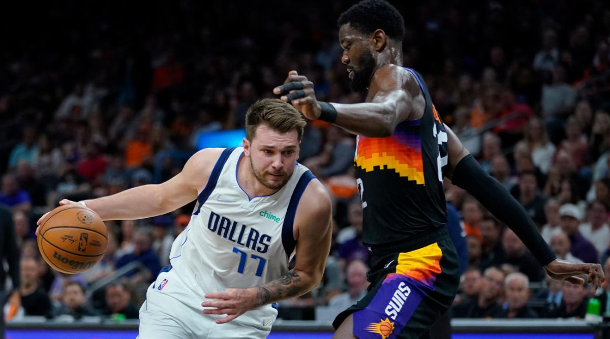 Dallas Mavericks guard Luka Doncic (77) drives around Phoenix Suns center Deandre Ayton (22) during the first half of Game 2 in the second round of the NBA Western Conference playoff series Wednesday, May 4, 2022, in Phoenix.