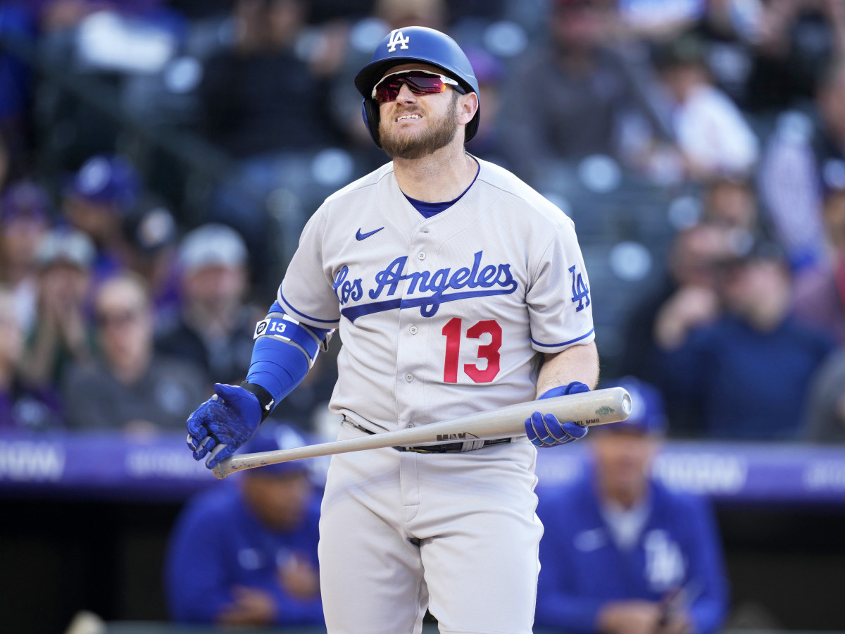 Los Angeles Dodgers’ Max Muncy reacts after striking out against Colorado Rockies relief pitcher Justin Lawrence in the ninth inning of a baseball game Friday, April 8, 2022, in Denver.