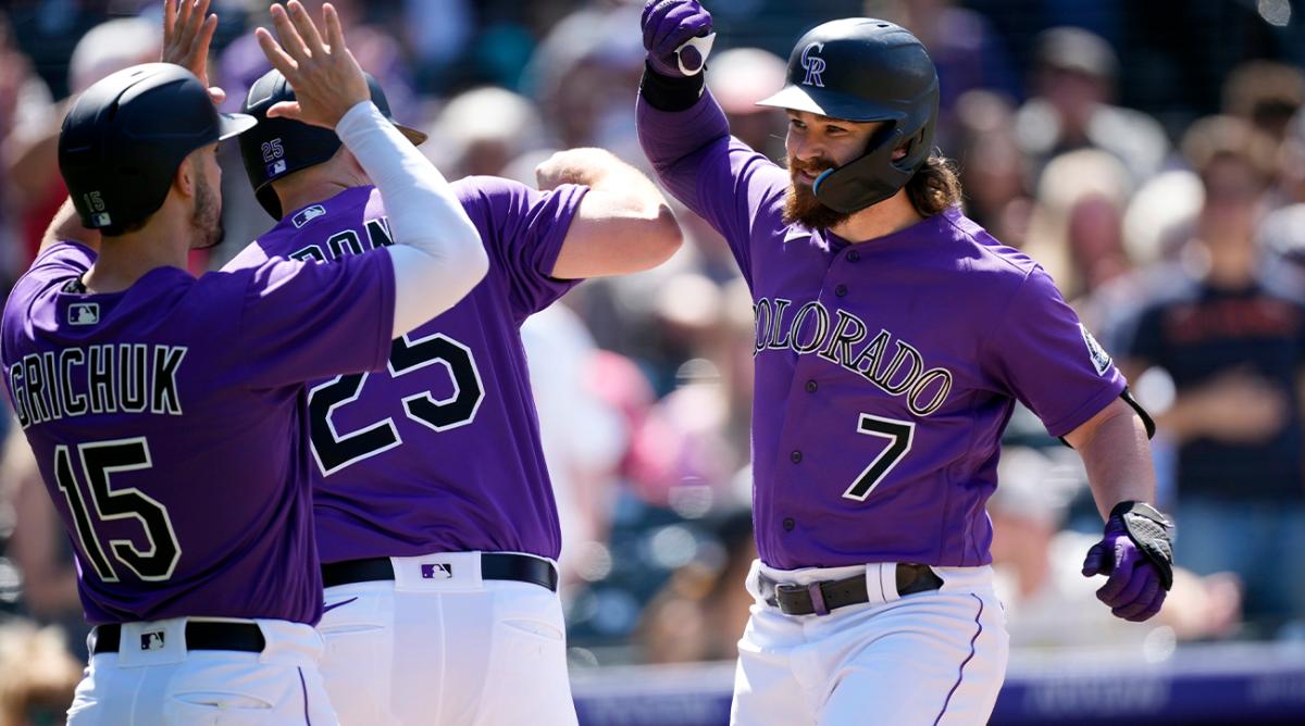Colorado Rockies’ Brendan Rodgers, right, celebrates with C.J. Cron, center, and Randal Grichuk after after hitting a three-run home run in the fifth inning of a baseball game against the Washington Nationals, Thursday, May 5, 2022, in Denver.