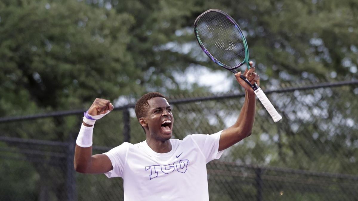 Luc Fomba celebrates after TCU's men's tennis team wins their first-round match in the NCAA tournament.