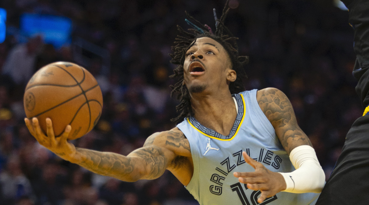 Memphis Grizzlies guard Ja Morant (12) shoots the ball against Golden State Warriors forward Kevon Looney (5) during the fourth quarter of game three of the second round for the 2022 NBA playoffs