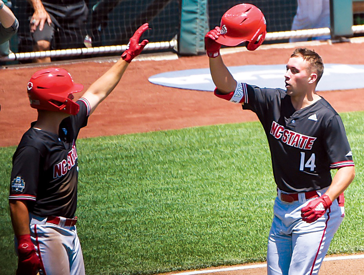 NC State Wolfpack outfielder Jonny Butler (14) celebrates a home run with outfielder Terrell Tatum (1) in the first inning against the Stanford Cardinal at TD Ameritrade Park.