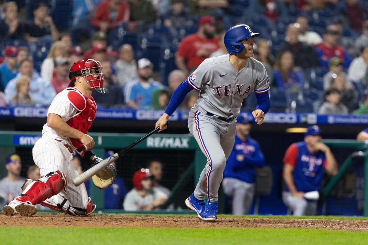May 4, 2022; Philadelphia, Pennsylvania, USA; Texas Rangers second baseman Brad Miller (13) hits a two RBI single against the Philadelphia Phillies during the tenth inning at Citizens Bank Park.