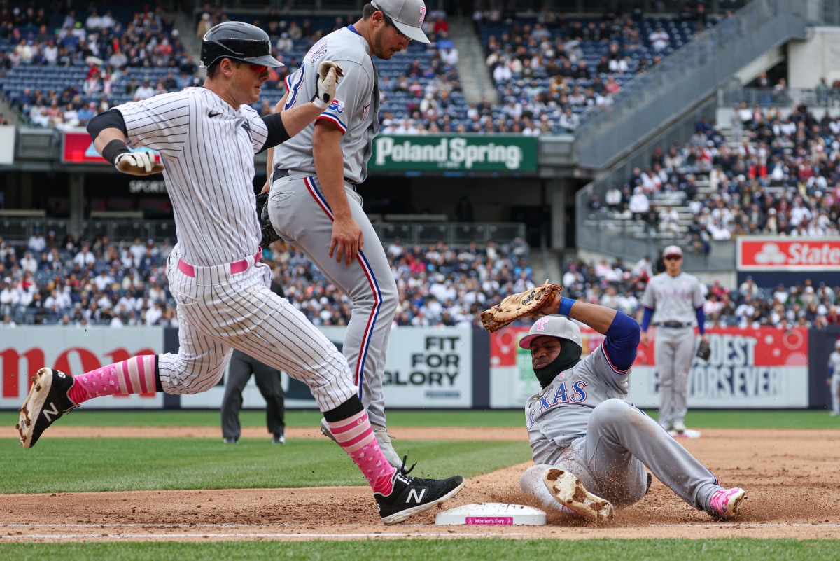 May 8, 2022; Bronx, New York, USA; Texas Rangers second baseman Marcus Semien (2) slides in to first base forcing out New York Yankees second baseman DJ LeMahieu (26) for an unassisted double play during the fourth inning at Yankee Stadium.