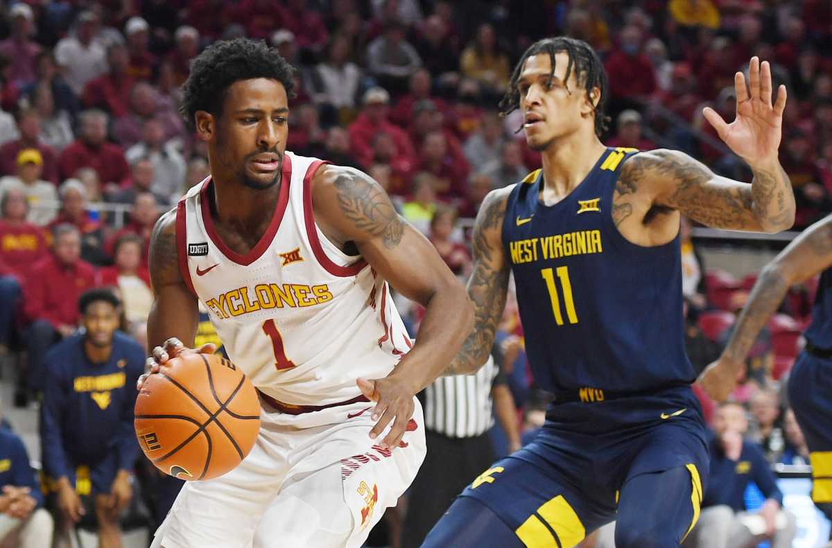 Iowa State Cyclones guard Izaiah Brockington (1) drives to the basket around West Virginia Mountaineers forward Pauly Paulicap (1) during the first half at Hilton Coliseum Wednesday, Feb. 23, 2022, in Ames, Iowa.