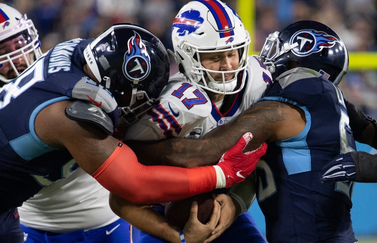 Tennessee Titans defensive end Jeffery Simmons (98) and outside linebacker Harold Landry (58) sack Buffalo Bills quarterback Josh Allen (17) during their game at Nissan Stadium Monday, Oct. 18, 2021 in Nashville, Tenn.