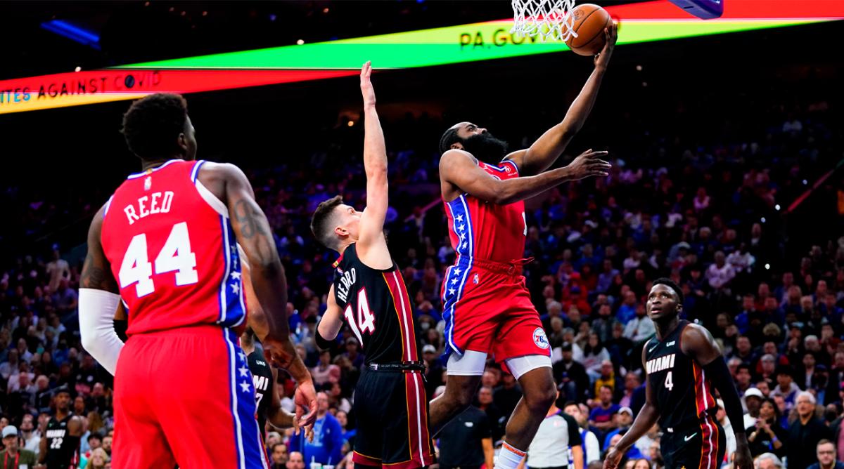 Philadelphia 76ers’ James Harden, right, goes up for a shot against Miami Heat’s Tyler Herro (14) during the second half of Game 4 of an NBA basketball second-round playoff series, Sunday, May 8, 2022, in Philadelphia.