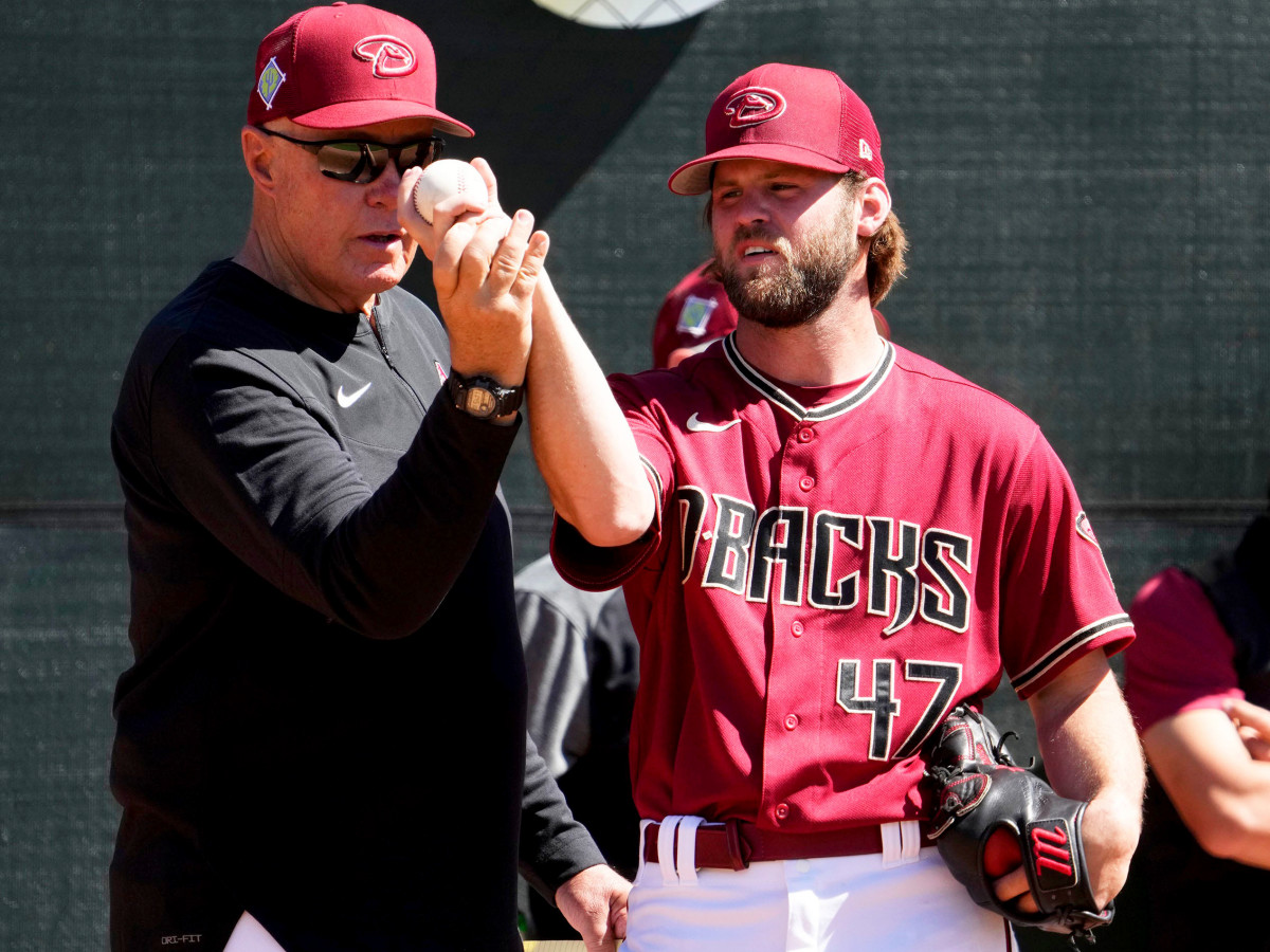 Mar 15, 2022; Scottsdale, Arizona, USA; Arizona Diamondbacks pitching coach Brent Strom works with pitcher Matt Peacock during spring training practice at Salt River Fields.