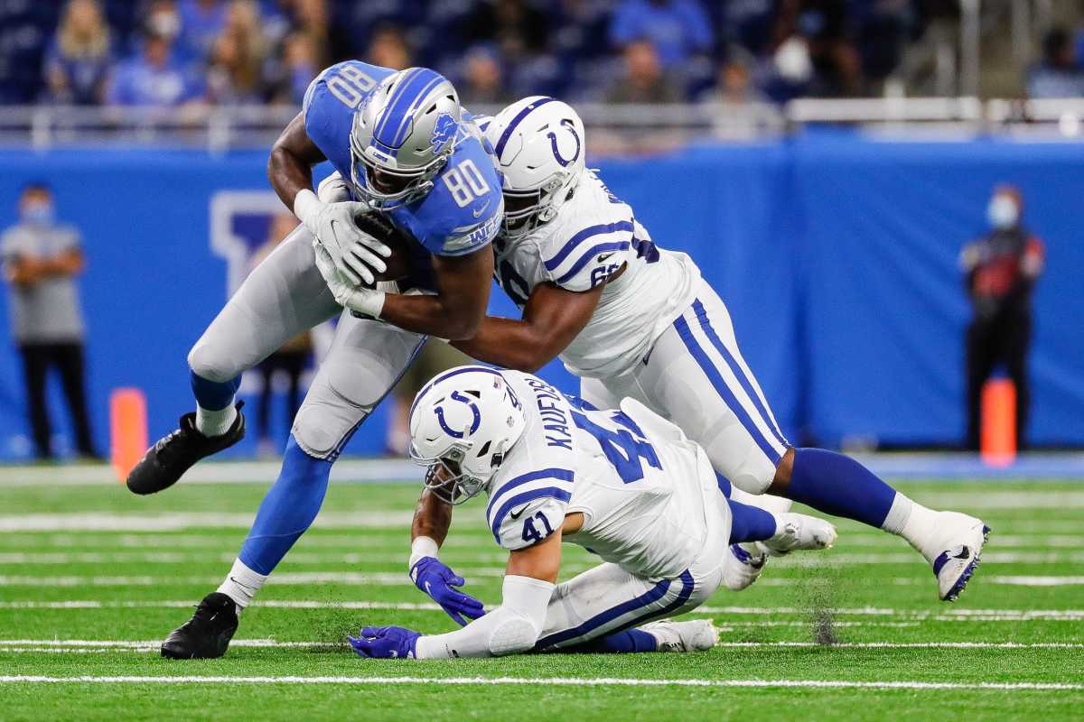 Detroit Lions tight end Darren Fells (80) is tackled by Indianapolis Colts defensive tackle Chris Williams (66) during the first half of a preseason game at Ford Field in Detroit, Friday, August 27, 2021.