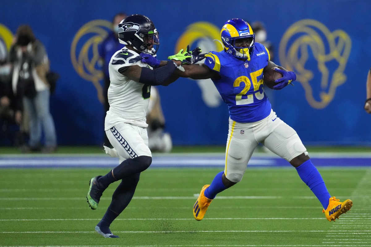 Dec 21, 2021; Los Angeles Rams running back Sony Michel (25) runs through Seattle safety Quandre Diggs (6). Mandatory Credit: Kirby Lee-USA TODAY Sports