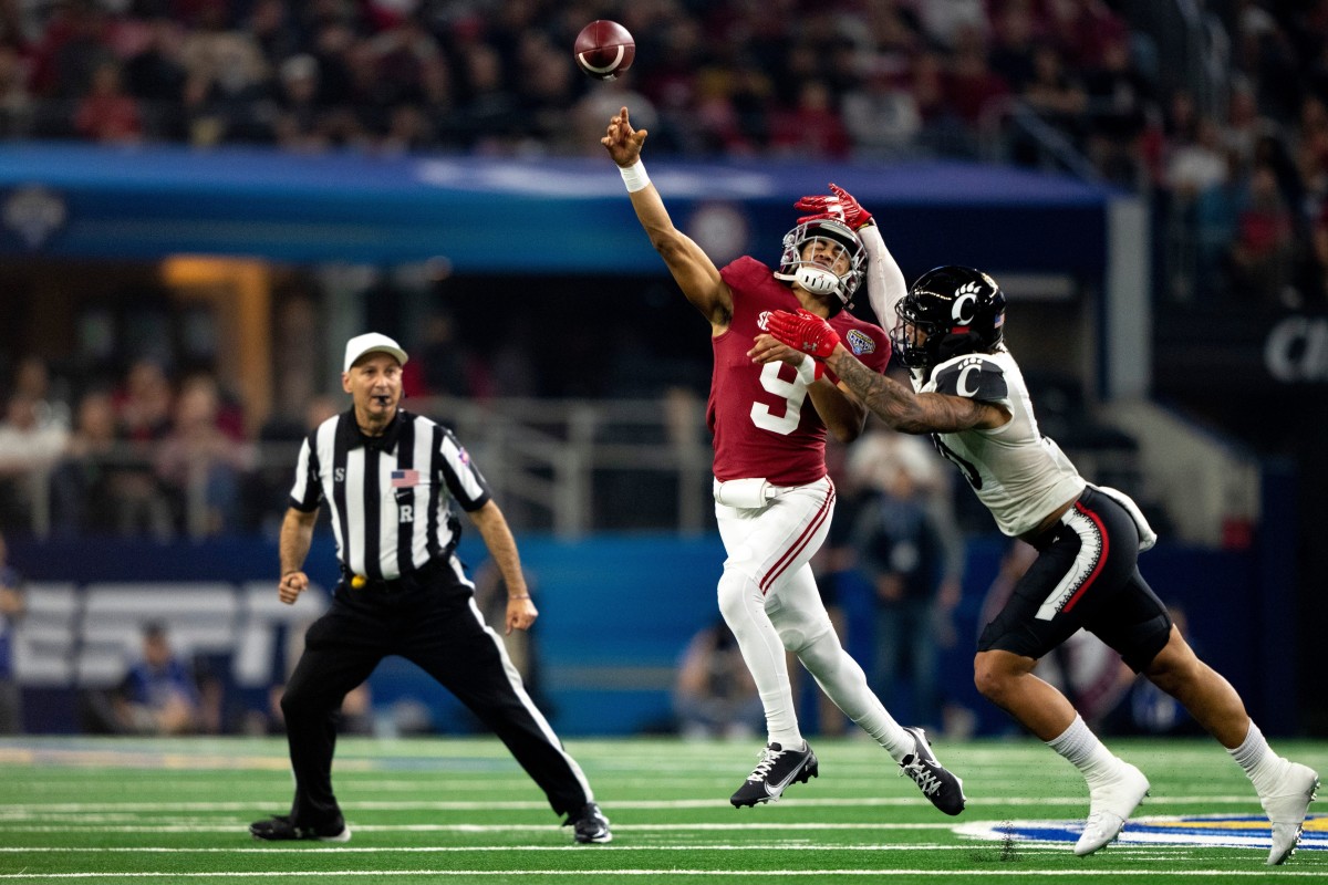 Cincinnati Bearcats linebacker Darrian Beavers (0) forces Alabama Crimson Tide quarterback Bryce Young (9) to throw the ball away in the second quarter the NCAA Playoff Semifinal at the Goodyear Cotton Bowl Classic on Friday, Dec. 31, 2021, at AT&T Stadium in Arlington, Texas.