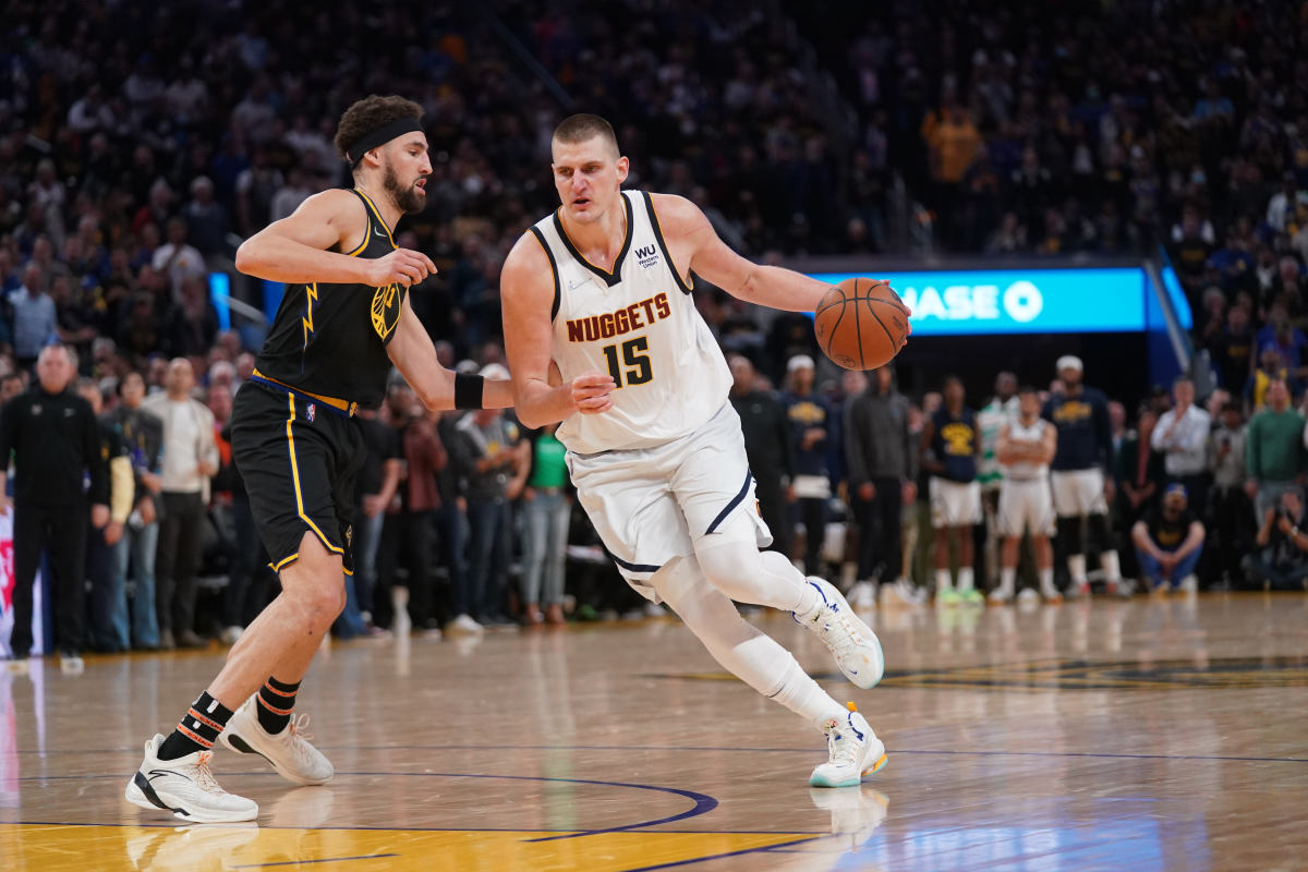 Apr 27, 2022; San Francisco, California, USA; Denver Nuggets center Nikola Jokic (15) dribbles past Golden State Warriors guard Klay Thompson (11) in the fourth quarter during game five of the first round for the 2022 NBA playoffs at Chase Center. Mandatory Credit: Cary Edmondson-USA TODAY Sports