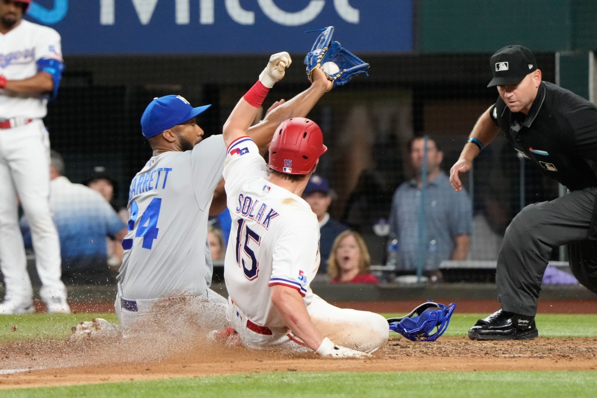 May 10, 2022; Arlington, Texas, USA; Texas Rangers designated hitter Nick Solak (15) scores against Kansas City Royals relief pitcher Amir Garrett (24) on a wild pitch during the sixth inning of a baseball game at Globe Life Field.