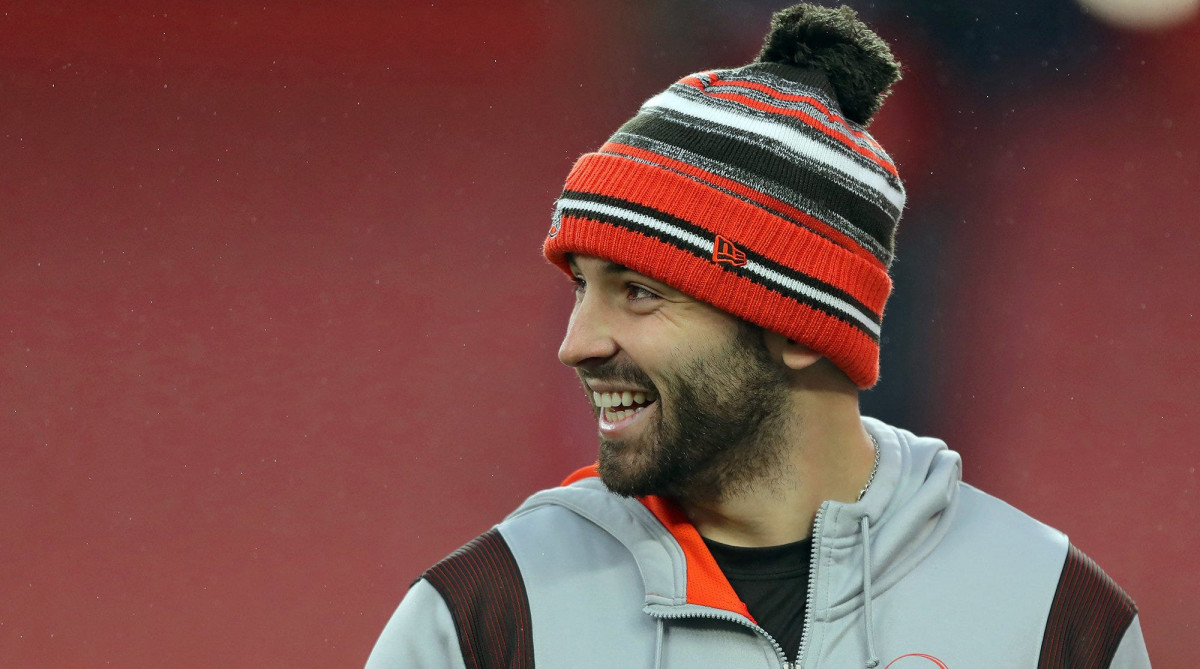 Browns quarterback Baker Mayfield laughs as he watches his teammates warm up before a game against the Cincinnati Bengals,