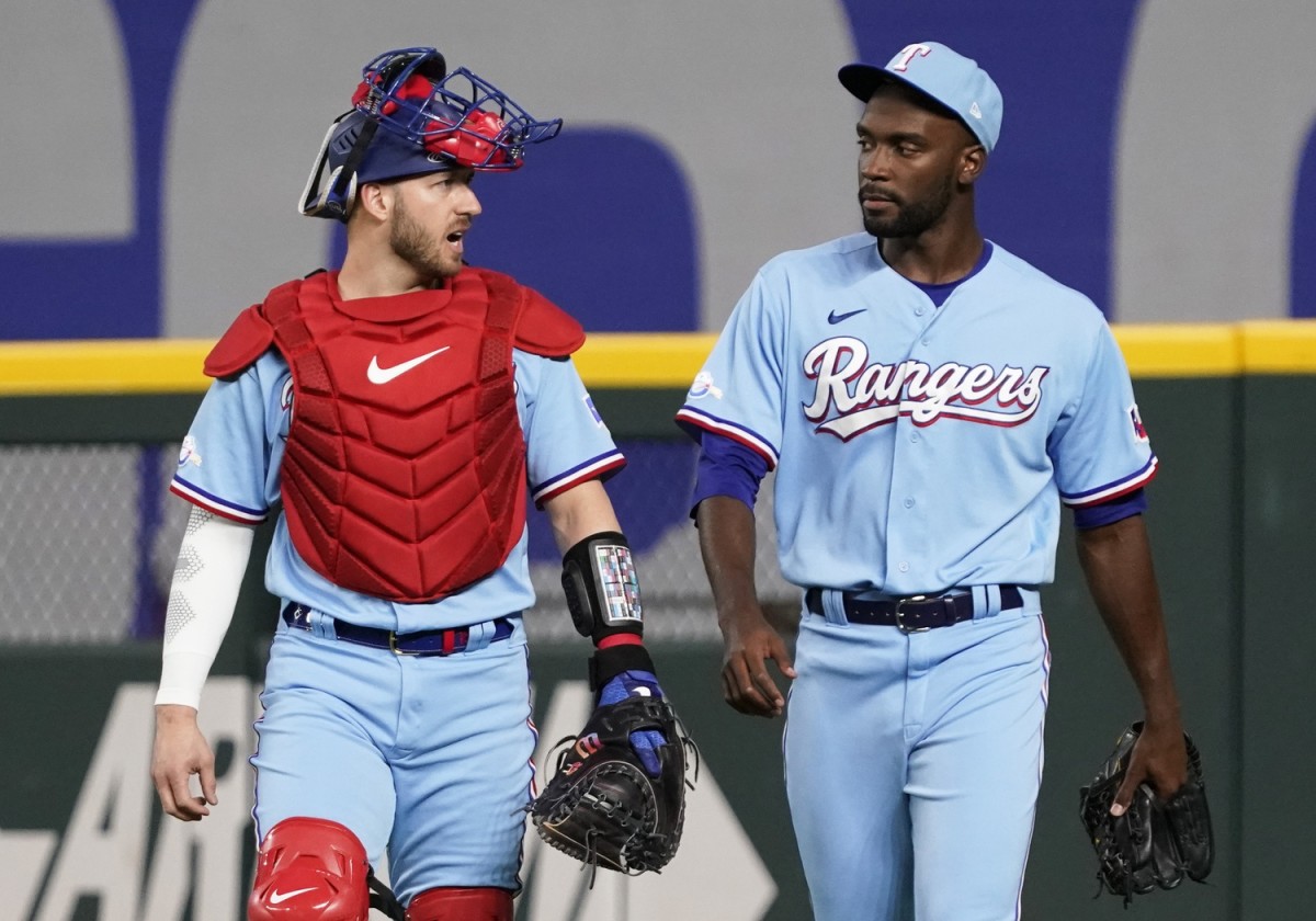 May 1, 2022; Arlington, Texas, USA; Texas Rangers catcher Mitch Garver (18) and starting pitcher Taylor Hearn (52) warm up before a game against the Atlanta Braves at Globe Life Field.