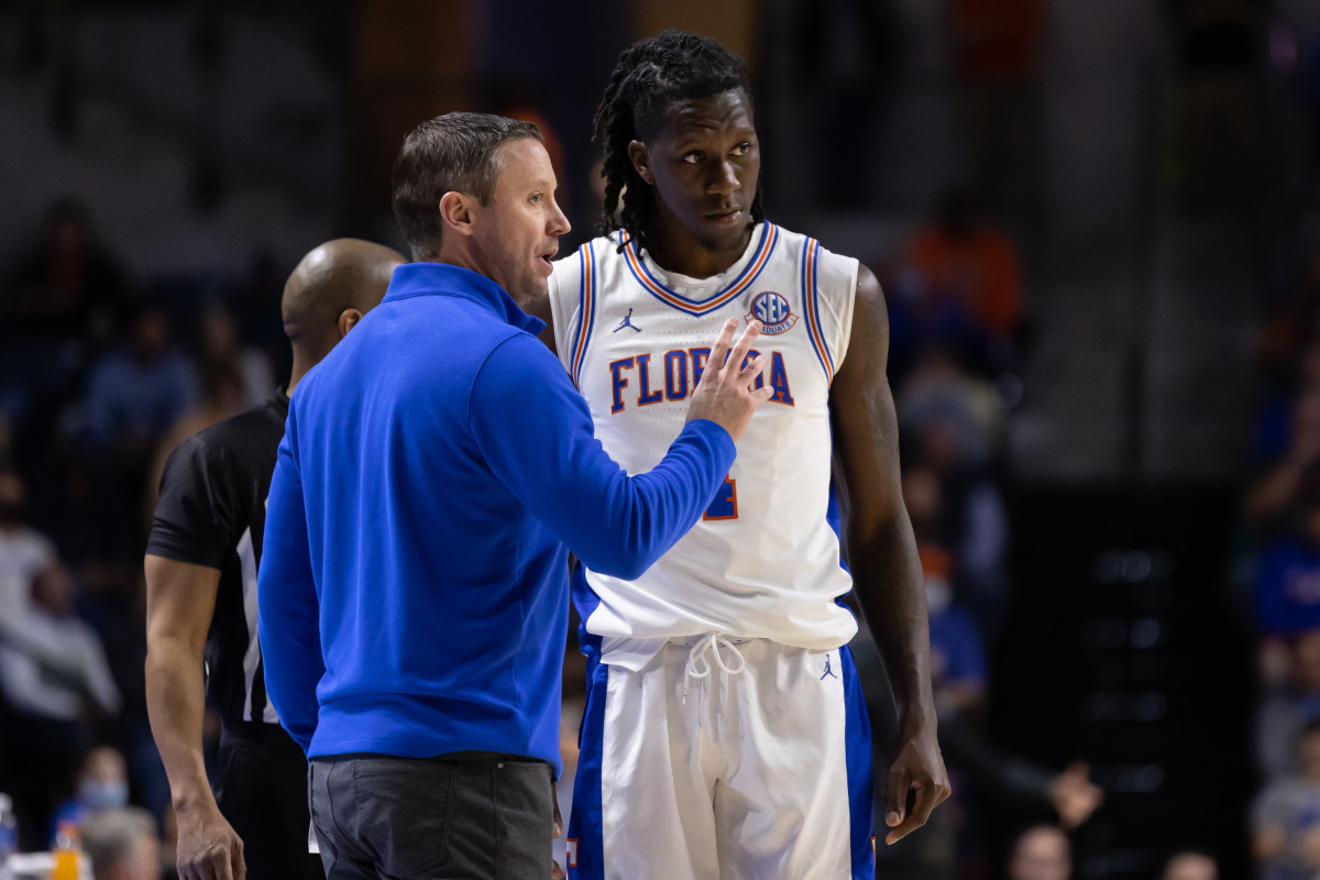 Florida Gators head coach Mike White talks with Florida Gators forward Anthony Duruji (4) during the second half against the Oklahoma State Cowboys at Billy Donovan Court at Exactech Arena.