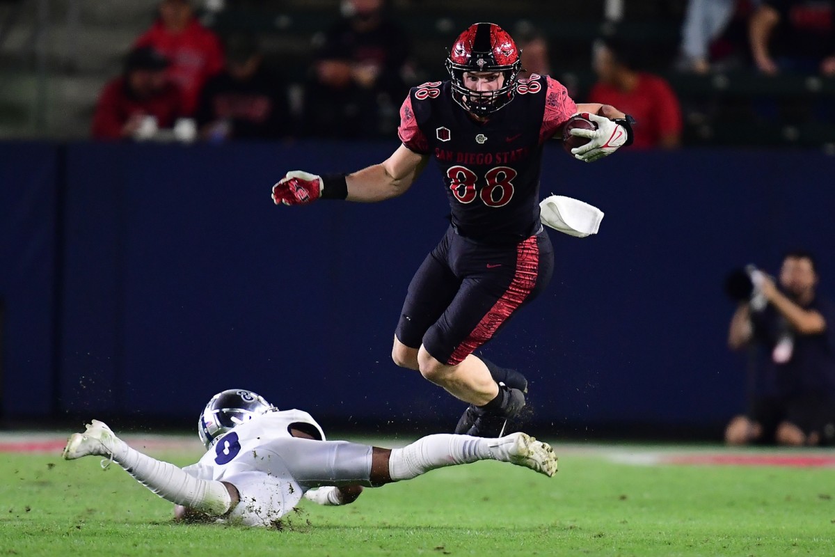 Nov 13, 2021; Carson, California, USA; San Diego State Aztecs tight end Daniel Bellinger (88) runs the ball against Nevada Wolf Pack defensive back JoJuan Clairborne (8) during the first half at Dignity Health Sports Park.