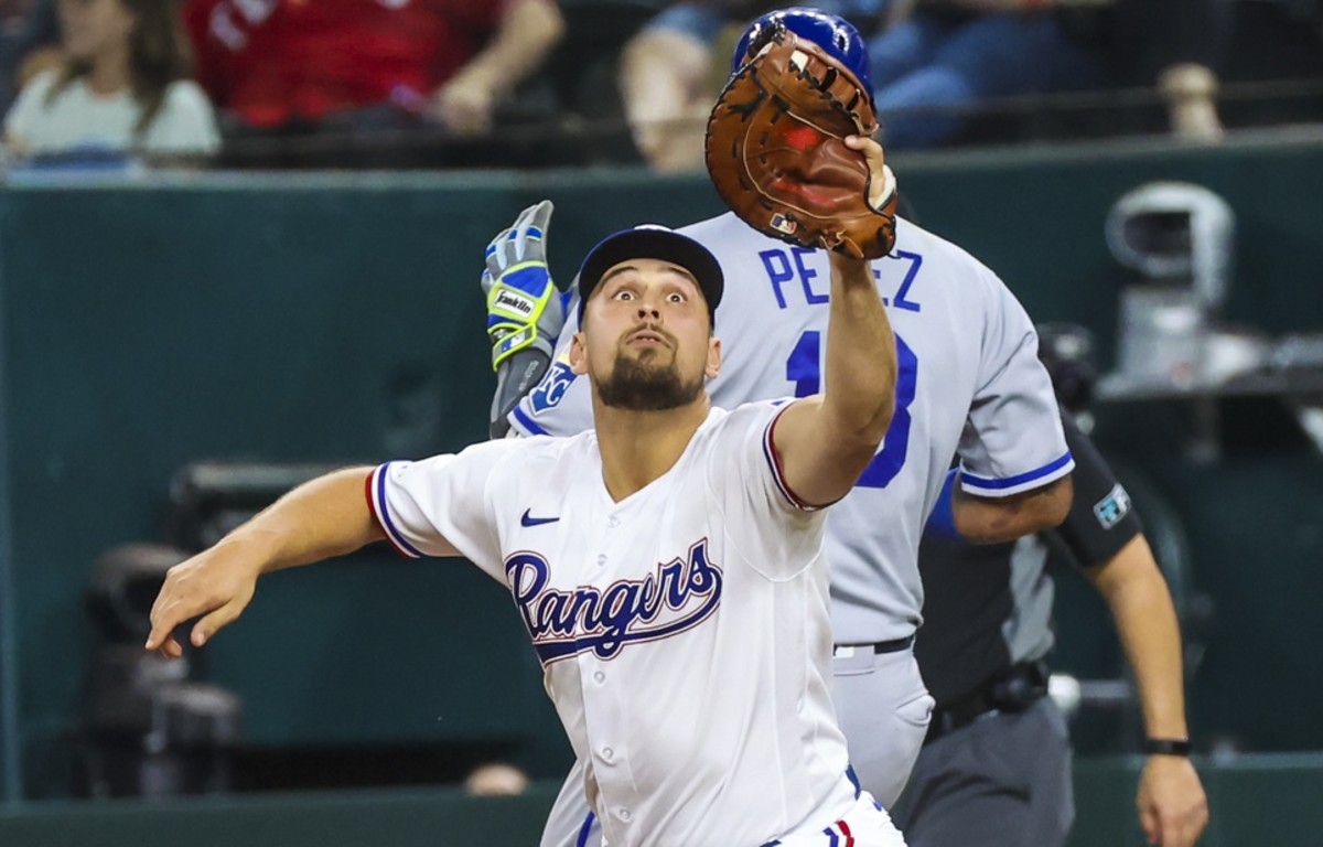 May 11, 2022; Arlington, Texas, USA; Texas Rangers first baseman Nathaniel Lowe (30) cannot make a catch at first base as Kansas City Royals catcher Salvador Perez (13) is ruled safe during the fifth inning at Globe Life Field.