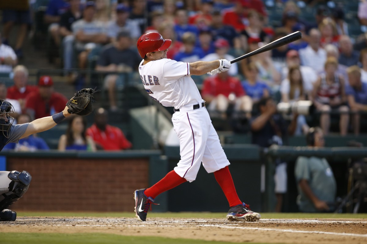 Jul 3, 2013; Arlington, TX, USA; Texas Rangers second baseman Ian Kinsler (5) hits a home run in the fifth inning of the game against the Seattle Mariners at the Rangers Ballpark in Arlington.