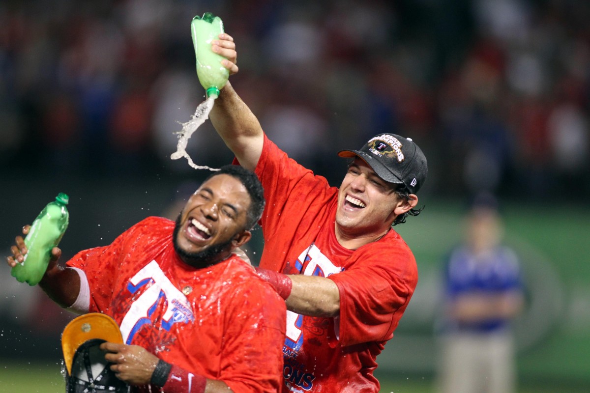 Oct 15, 2011; Arlington, TX, USA; Texas Rangers second baseman Ian Kinsler (right) dumps ginger ale on the head of shortstop Elvis Andrus (left) after defeating the Detroit Tigers 15-5 in game six of the 2011 ALCS at Rangers Ballpark.