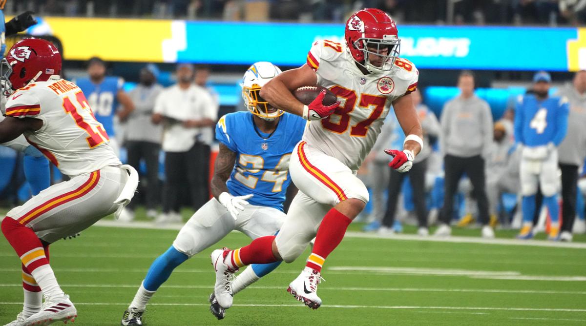 Dec 16, 2021; Inglewood, California, USA; Kansas City Chiefs tight end Travis Kelce (87) is pursued by Los Angeles Chargers safety Nasir Adderley (24) on a touchdown reception in overtime against the Los Angeles Chargers at SoFi Stadium.