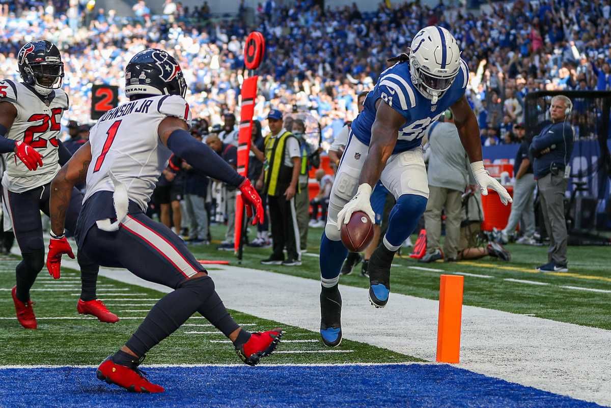 Indianapolis Colts tight end Mo Alie-Cox (81) reaches to keep the ball inside the pylon as he moves past Houston Texans safety Lonnie Johnson (1) and into the end zone for a touchdown Sunday, Oct. 17, 2021, during a game against the Houston Texans at Lucas Oil Stadium in Indianapolis. Jenna Watson Poy 2021 025