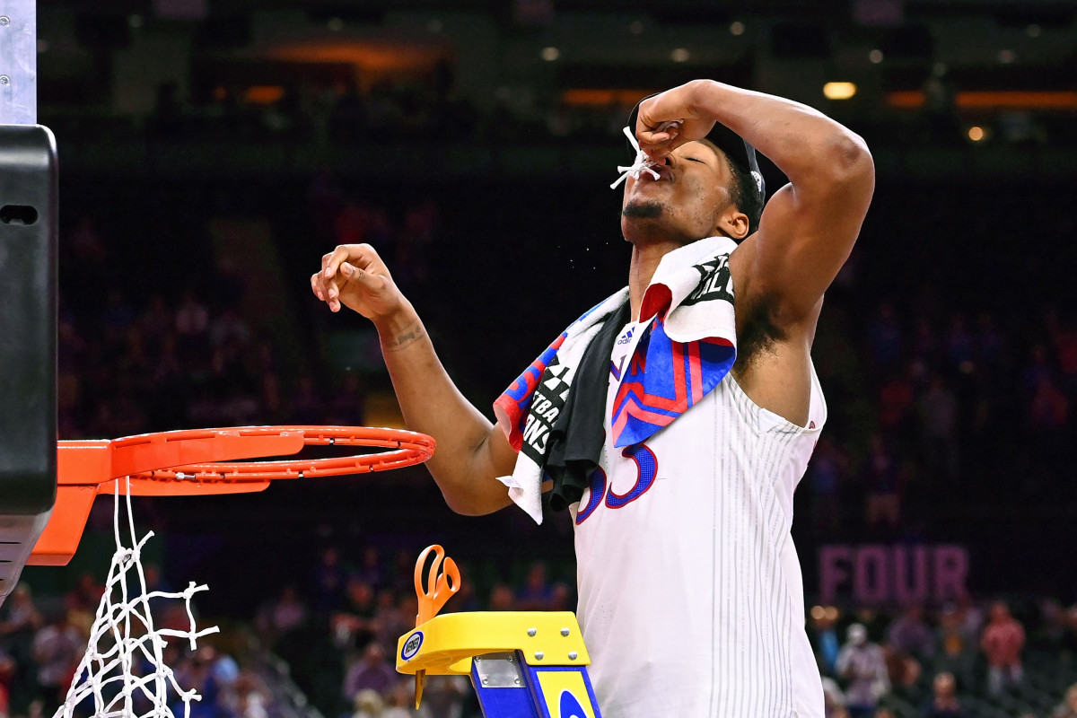 Kansas Jayhawks forward David McCormack (33) reacts after cutting down the net after their win against the North Carolina Tar Heels in the 2022 NCAA men's basketball tournament Final Four championship game at Caesars Superdome.