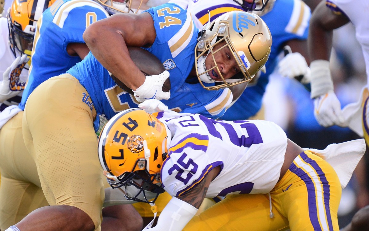 Sep 4, 2021; Pasadena, California, USA; UCLA Bruins running back Zach Charbonnet (24) runs the ball against Louisiana State Tigers cornerback Cordale Flott (25) during the first half the at the Rose Bowl.