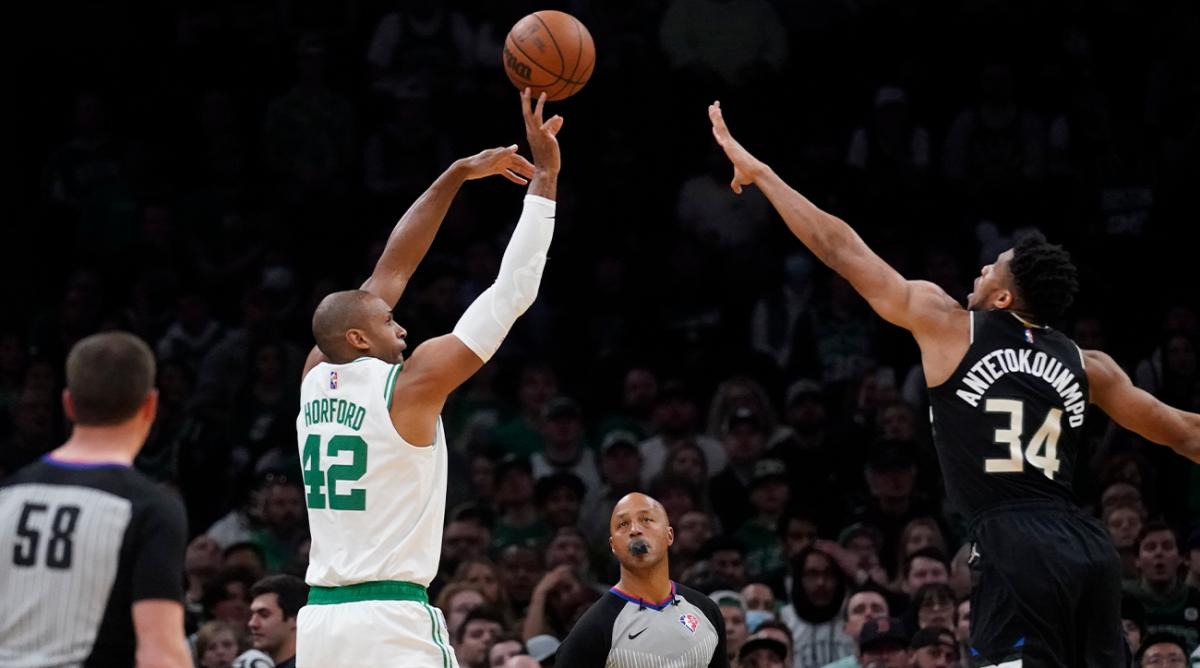 Boston Celtics center Al Horford (42) shoots over Milwaukee Bucks forward Giannis Antetokounmpo (34) during the first half of Game 5 of an Eastern Conference semifinal in the NBA basketball playoffs, Wednesday, May 11, 2022, in Boston.