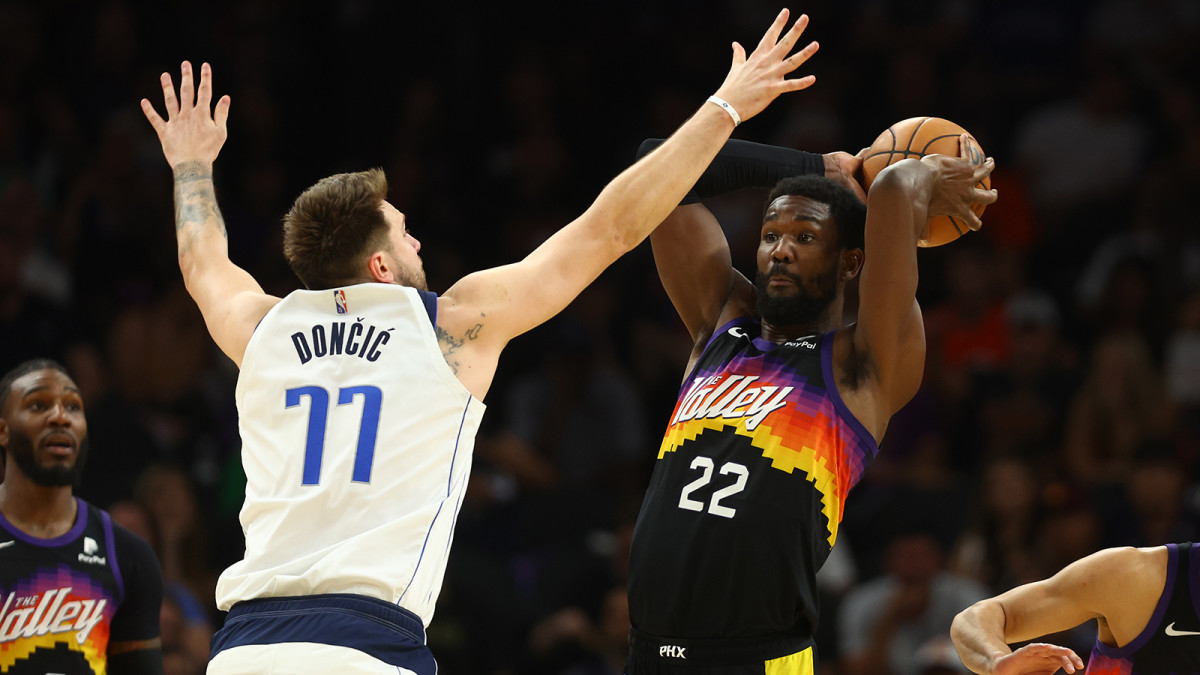 hoenix Suns center Deandre Ayton (22) controls the ball against Dallas Mavericks guard Luka Doncic.