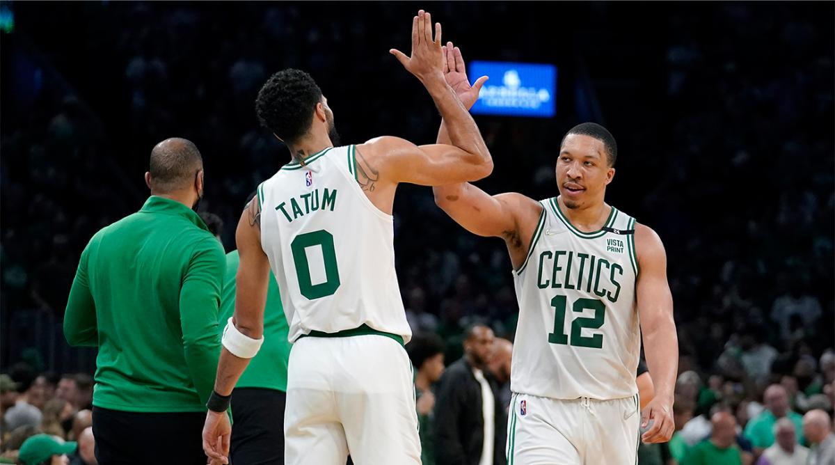 Boston Celtics forward Jayson Tatum (0) celebrates with forward Grant Williams (12) as the Celtics lead the Milwaukee Bucks during the second half of Game 7 of an NBA basketball Eastern Conference semifinals playoff series, Sunday, May 15, 2022, in Boston.