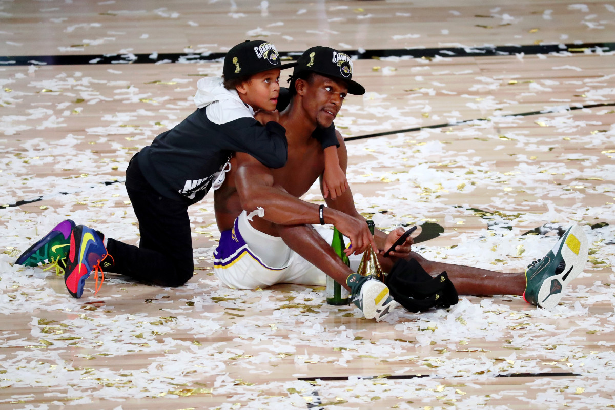 Los Angeles Lakers guard Rajon Rondo (9) sits on the court with his son after game six of the 2020 NBA Finals at AdventHealth Arena. The Los Angeles Lakers won 106-93 to win the series.