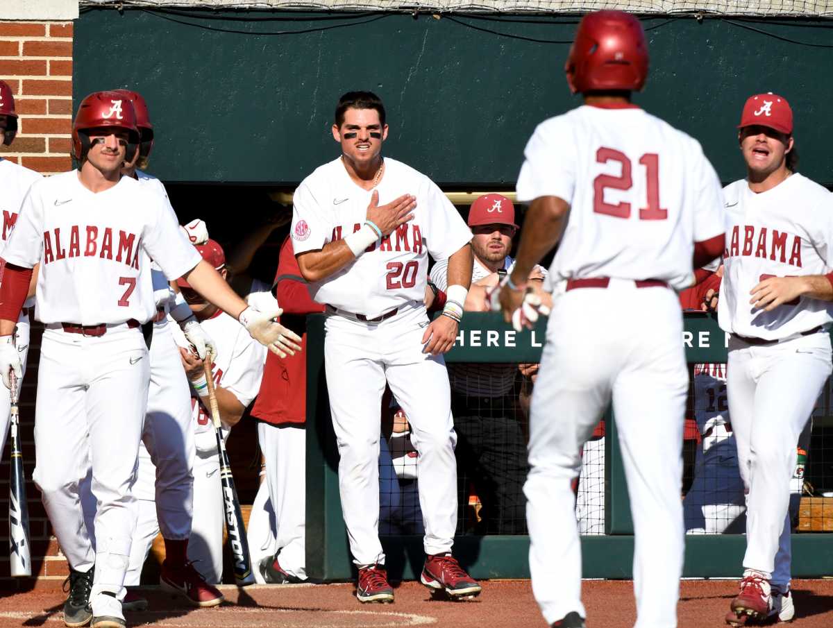 Alabama outfielder Tommy Seidl (20) and other players wait to greet Alabama outfielder Andrew Pinckney (21) after he scored on a wild pitch while playing against Murray State at Sewell-Thomas Stadium Friday, March 4, 2022.