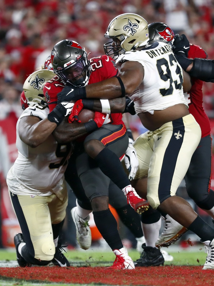 Tampa Bay Buccaneers running back Ronald Jones (27) tackled by New Orleans Saints defensive tackles Shy Tuttle (99) and David Onyemata (93). Mandatory Credit: Kim Klement-USA TODAY Sports