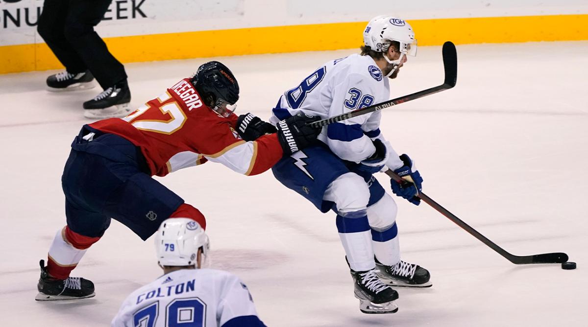 Tampa Bay Lightning left wing Brandon Hagel (38) skates with the puck as Florida Panthers defenseman MacKenzie Weegar (52) defends during the third period of an NHL hockey game, Sunday, April 24, 2022, in Sunrise, Fla. The Lightning won 8-4.
