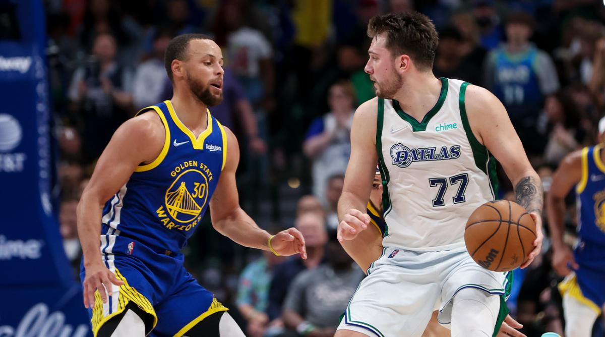 Mar 3, 2022; Dallas, Texas, USA; Dallas Mavericks guard Luka Doncic (77) dribbles as Golden State Warriors guard Stephen Curry (30) defends during the game at American Airlines Center.