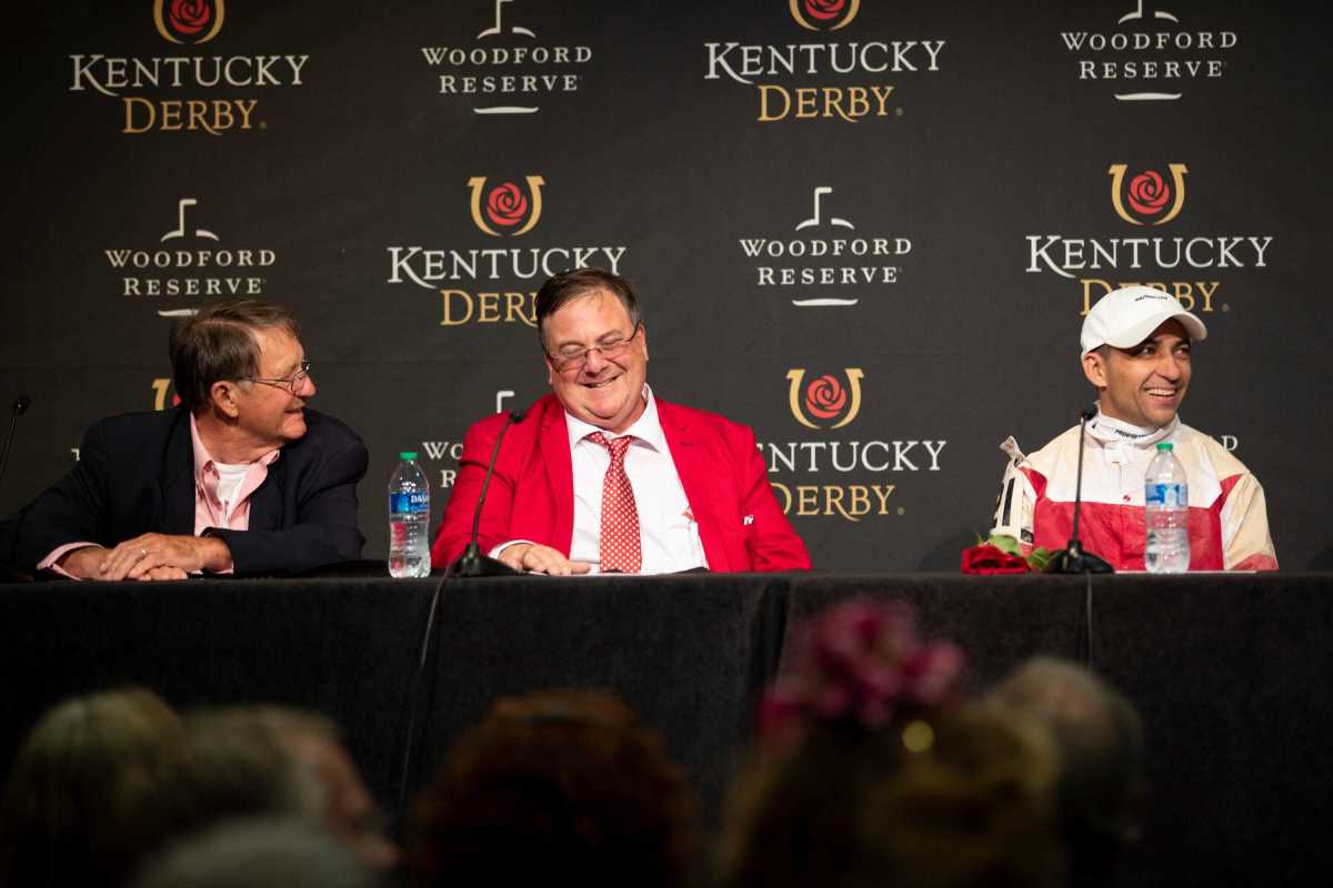 Herbie Reed (left) and son Eric (center) celebrate their shocking Kentucky Derby win with jockey Sonny Leon.