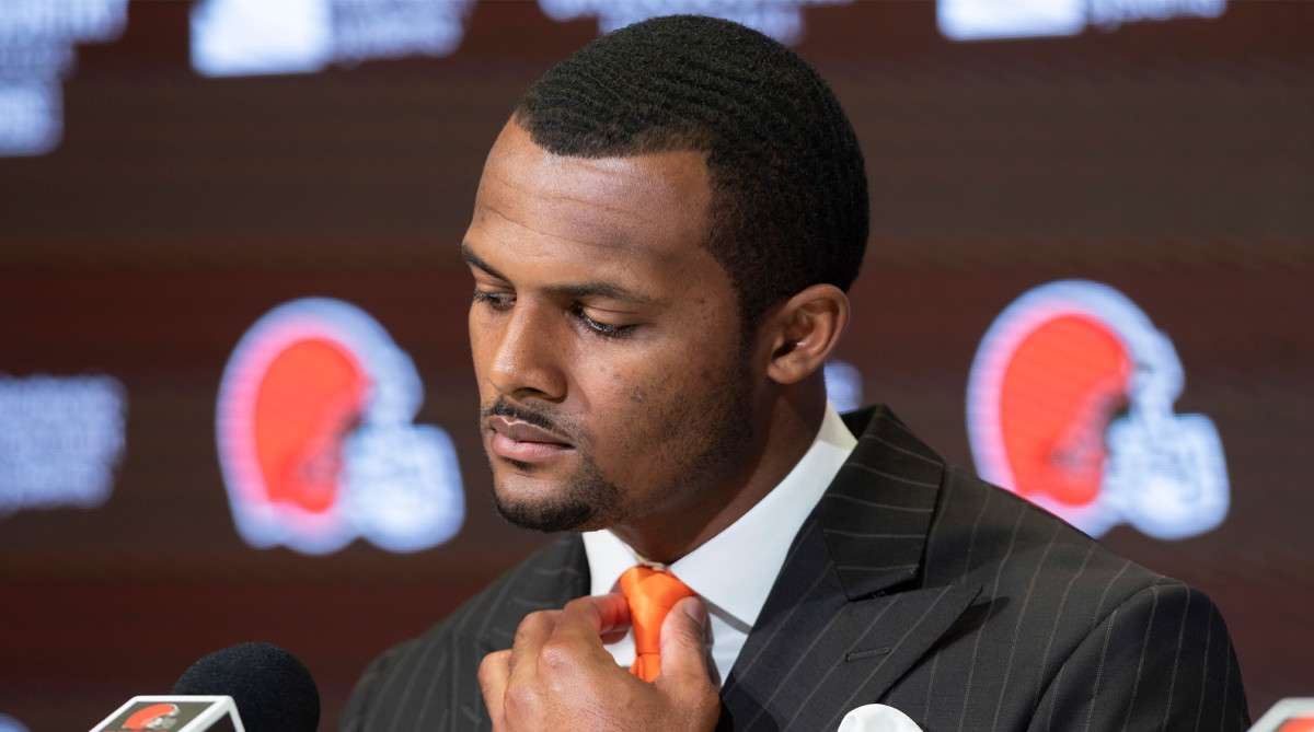 Mar 25, 2022; Berea, OH, USA; Cleveland Browns quarterback Deshaun Watson adjusts his tie during a press conference at the CrossCountry Mortgage Campus.