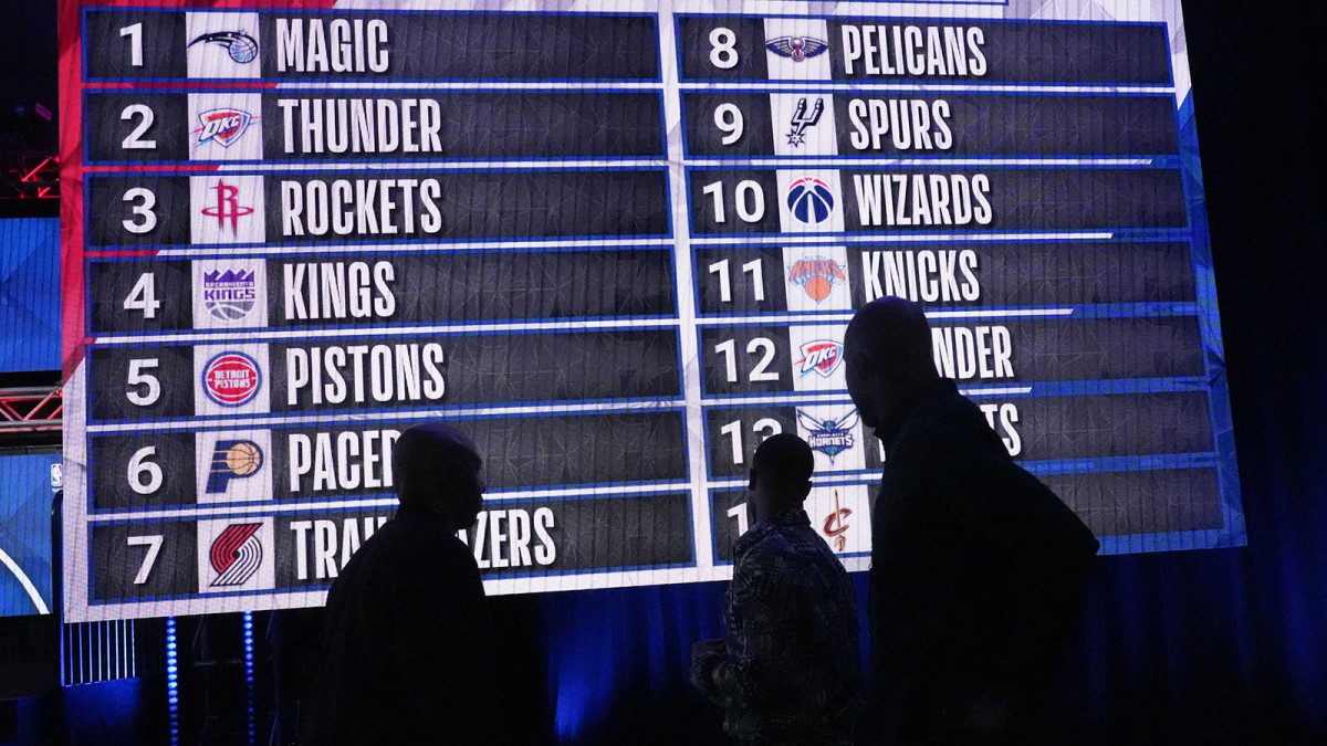 People look at the draft lottery order after the 2022 NBA Draft Lottery at McCormick Place.