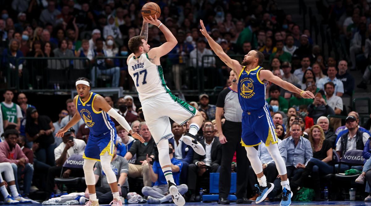 Mar 3, 2022; Dallas, Texas, USA; Dallas Mavericks guard Luka Doncic (77) shoots over Golden State Warriors guard Stephen Curry (30) during the game at American Airlines Center.