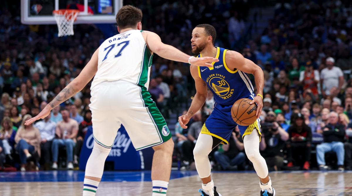 Mar 3, 2022; Dallas, Texas, USA; Dallas Mavericks guard Luka Doncic (77) guards Golden State Warriors guard Stephen Curry (30) during the game at American Airlines Center.