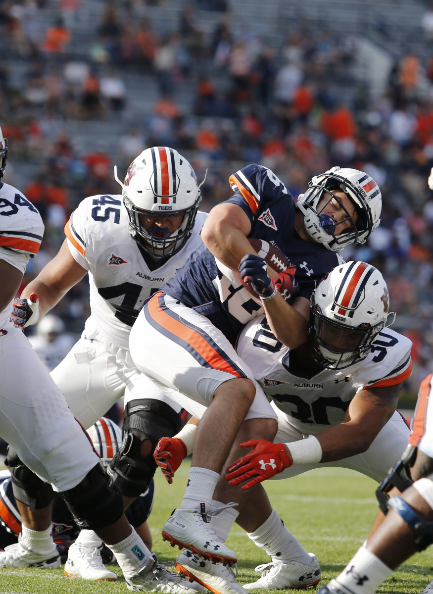 Apr 13, 2019; Auburn, AL, USA; Auburn Tigers running back Jacob Jasinski (46) is tackled by linebacker Michael Harris (30) and defensive end Caleb Johnson (45) during the fourth quarter of the A-Day game at Jordan-Hare Stadium. Mandatory Credit: John Reed-USA TODAY Sports